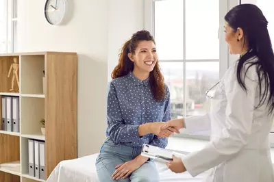 doctor shaking hands with new patient